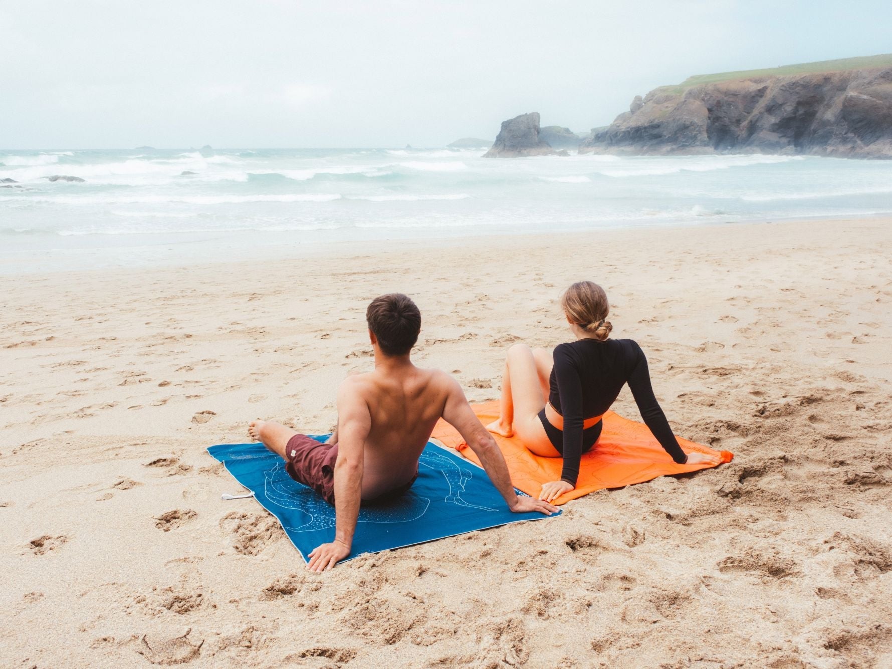 Couple of beach resting on Lifeventure Printed SoftFibre Recycled Towels