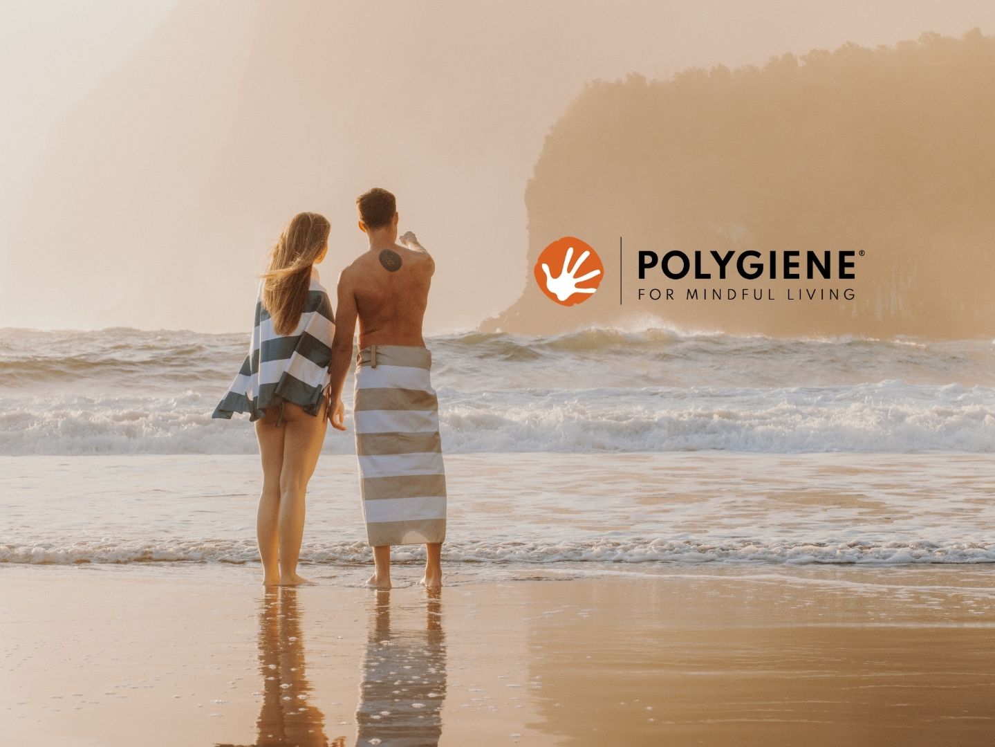 Couple on beach with Lifeventure Recycled Towels and Polygiene logo